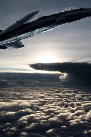 Fighter Aircraft Flying Out Of The Clouds