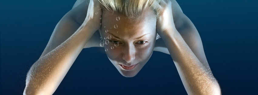 Girl Under Water Immersing Blonde Bubbles