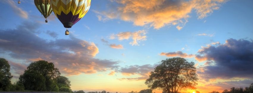 Hot Air Balloons Flying Over Land