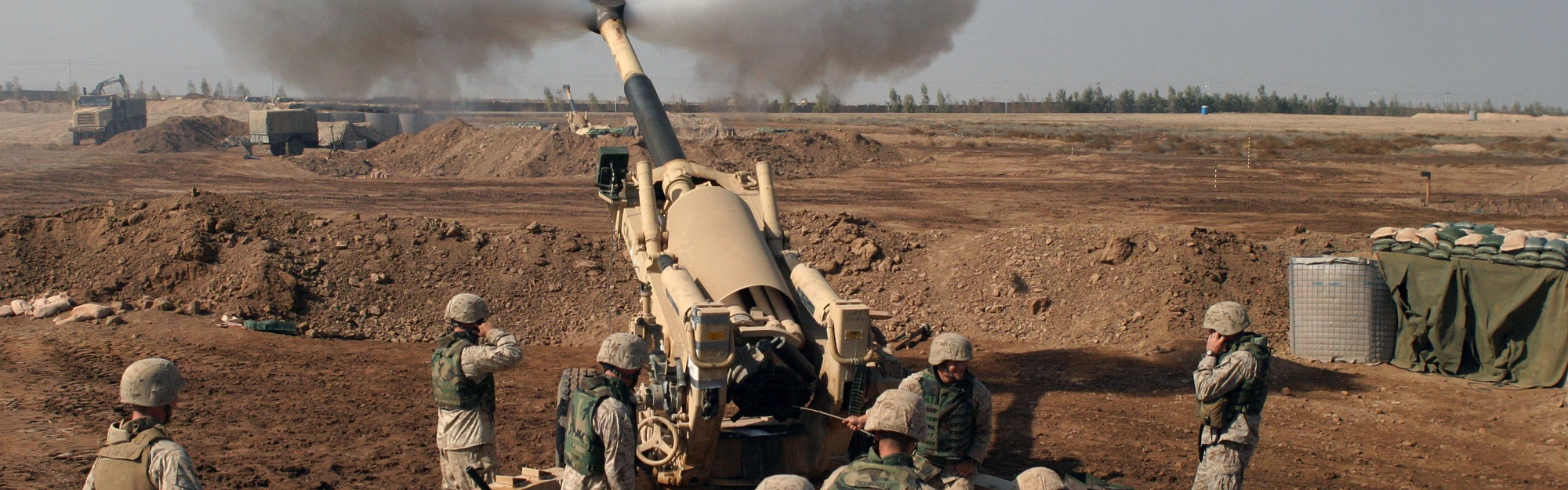 Soldiers Fire From Howitzers